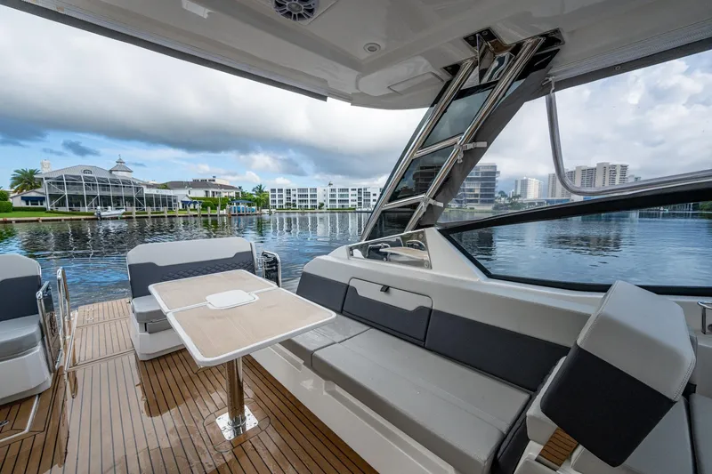Slide: The Image of Luxurious 2023 Aquila 32 Power Cat interior with waterfront view and modern seating. - 14