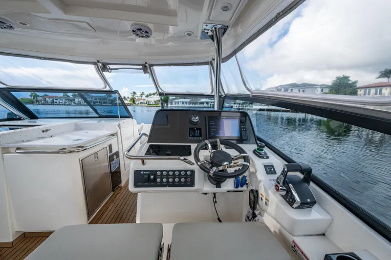 Slide: The Image of 2023 Aquila 32 Power Cat cockpit with modern controls and waterfront view. - 20