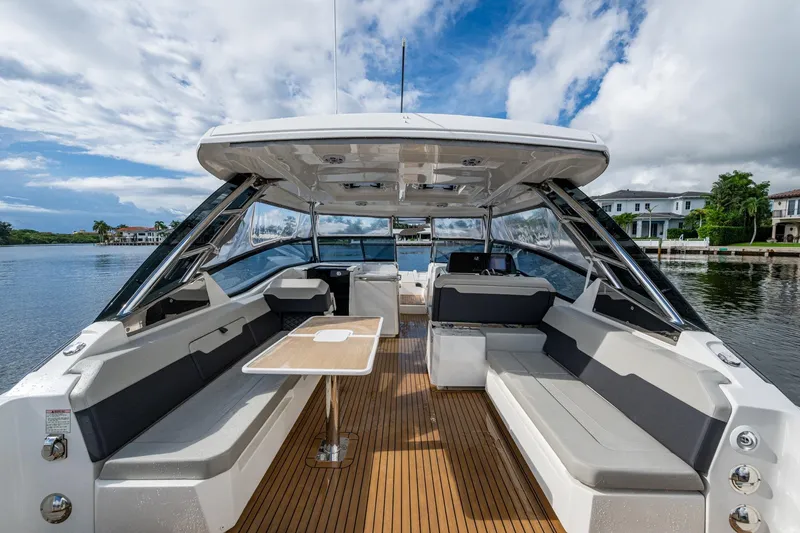 Slide: The Image of 2023 Aquila 32 Power Cat interior with spacious seating and elegant design on a serene waterway. - 21