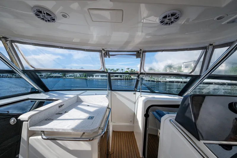 Slide: The Image of Interior view of 2023 Aquila 32 Power Cat, showcasing helm and seating area. - 28