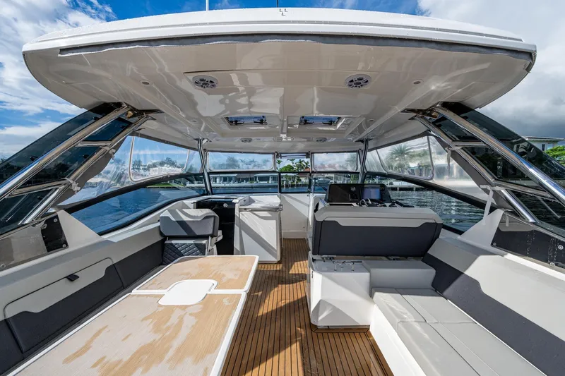Slide: The Image of 2023 Aquila 32 Power Cat interior with modern seating and sleek design on open water. - 30