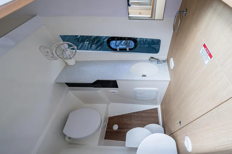 Slide: The Image of Modern bathroom interior of 2023 Aquila 32 Power Cat, featuring sleek design and compact amenities. - 35