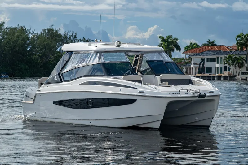 Slide: The Image of 2023 Aquila 32 Power Catamaran on calm water, modern design, luxury boating. - 40