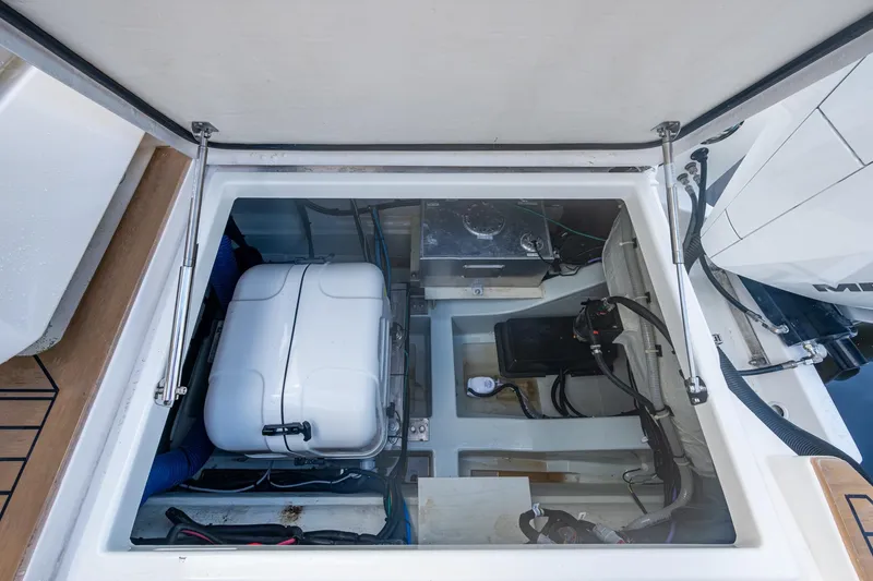 Slide: The Image of 2023 Aquila 32 Power Cat engine compartment with visible components and wiring. - 5