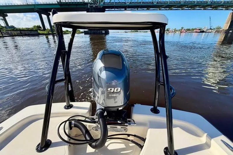 Slide: The Image of 2023 Scout 177 Sport boat with Yamaha 90 engine on a river under a bridge. - 10