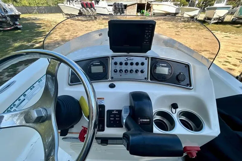 Slide: The Image of 2023 Scout 177 Sport boat dashboard with steering wheel and Yamaha controls. - 7