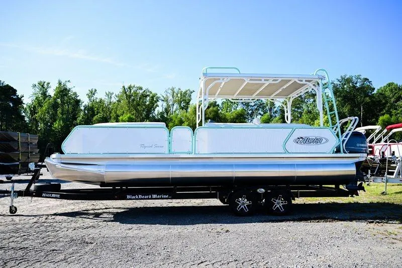The Image of 2022 Aloha Pontoon 260 Tropical Series Sundeck on trailer, parked outdoors. - 0