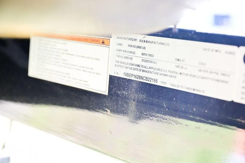 Slide: The Image of Close-up of a manufacturer's label on a 2022 Aloha Pontoon 260 Tropical Series Sundeck. - 9