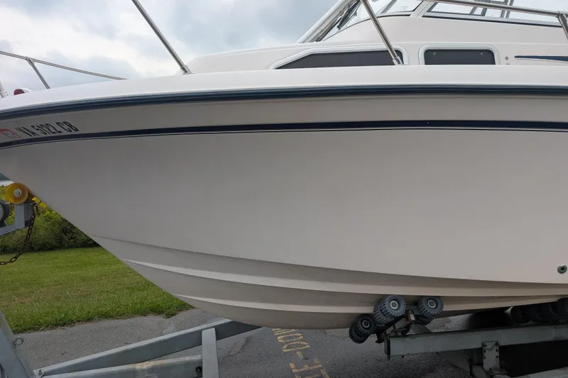 Slide: The Image of 2002 Grady-White Voyager 248 boat on trailer, side view, cloudy sky background. - 10