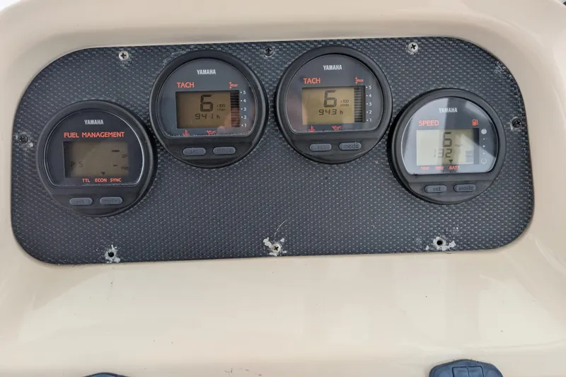 Slide: The Image of Yamaha gauges on 2002 Grady-White Voyager 248 dashboard, displaying tachometer and speedometer readings. - 14