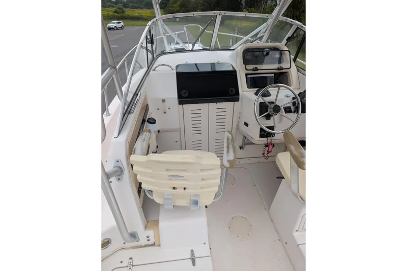 Slide: The Image of 2002 Grady-White Voyager 248 boat interior with steering wheel and seating. - 4