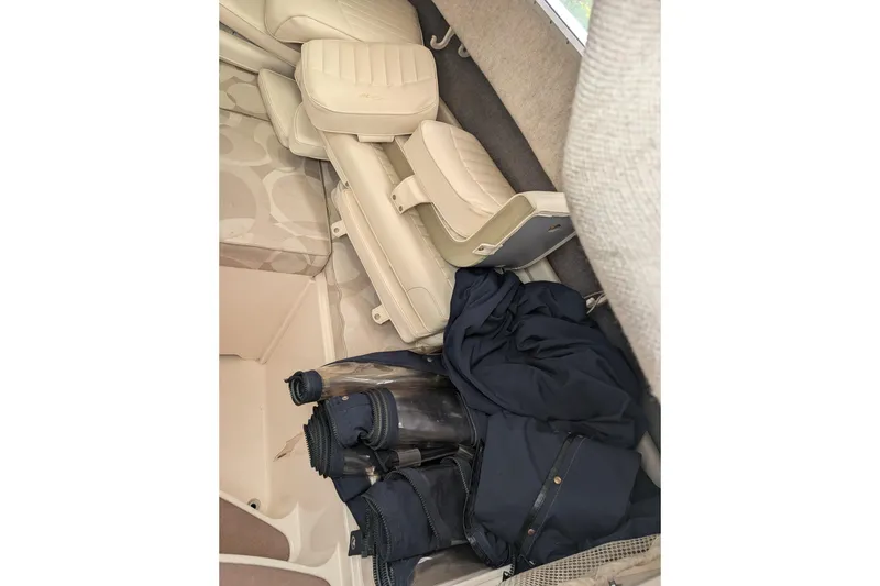 Slide: The Image of Interior of 2002 Grady-White Voyager 248 boat with folded seats and stored gear. - 5