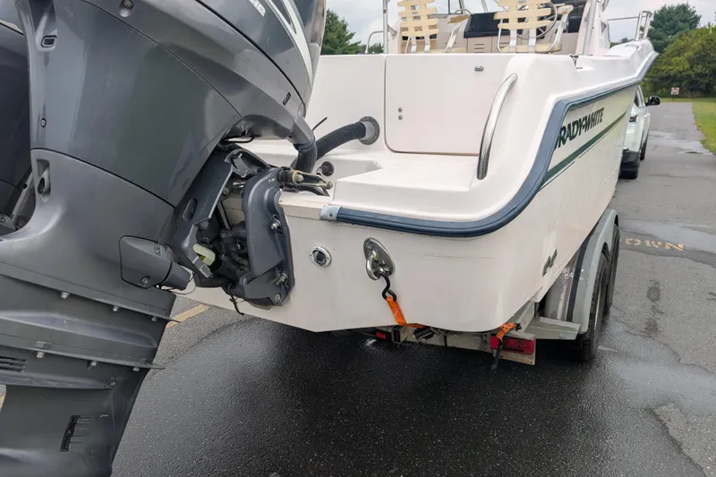 Slide: The Image of 2002 Grady-White Voyager 248 boat on trailer, featuring outboard motor. - 8