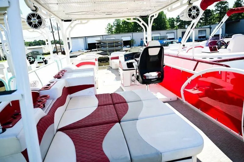 Slide: The Image of 2023 Aloha Pontoon 260 Paradise Series Sundeck with red and white seating and modern design. - 12