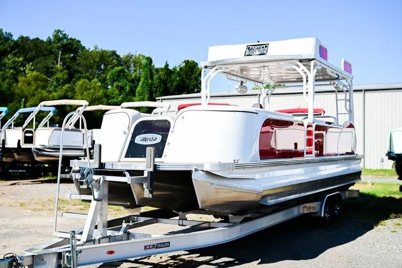 Slide: The Image of 2023 Aloha Pontoon 260 Paradise Series Sundeck on trailer, parked outdoors. - 2
