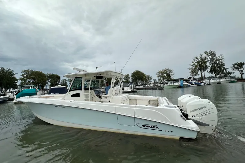 The Image of 2016 Boston Whaler 370 Outrage boat on water, featuring twin Mercury engines. - 0