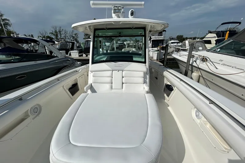 Slide: The Image of 2016 Boston Whaler 370 Outrage boat docked under cloudy skies. - 11