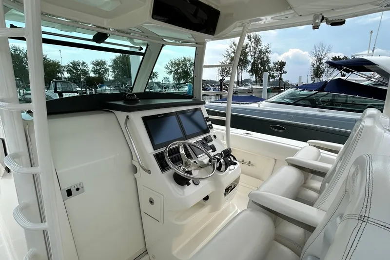 Slide: The Image of 2016 Boston Whaler 370 Outrage boat with a well-equipped outdoor kitchen area. - 14