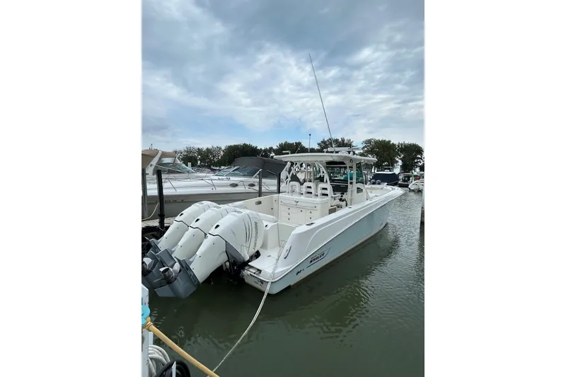 Slide: The Image of 2016 Boston Whaler 370 Outrage boat docked with triple outboard engines. - 6