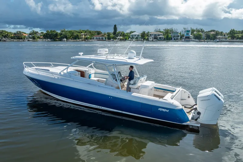 The Image of 2018 Intrepid 407 boat on calm water, featuring sleek design and powerful Mercury engines. - 0
