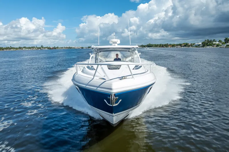Slide: The Image of 2018 Intrepid 407 boat cruising on a sunny day with blue skies and calm waters. - 13