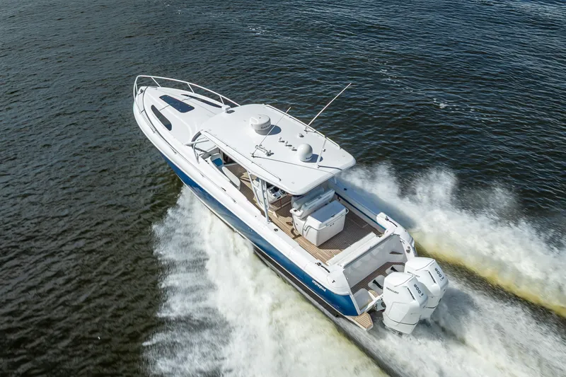 Slide: The Image of 2018 Intrepid 407 boat cruising on open water, showcasing sleek design and powerful engines. - 14