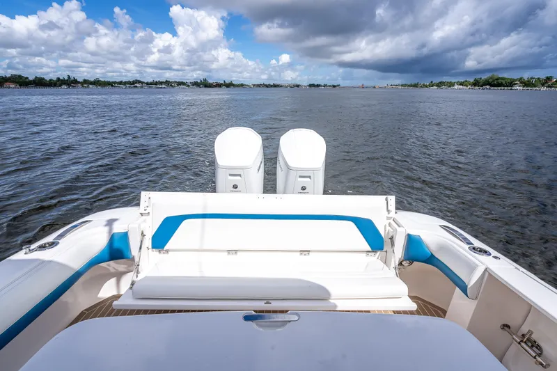 Slide: The Image of 2018 Intrepid 407 boat with dual engines on a calm waterway under cloudy skies. - 16