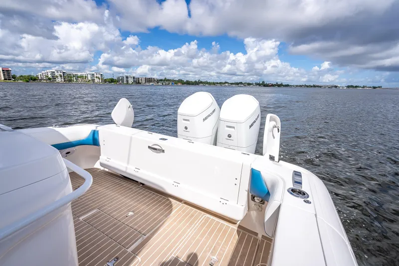 Slide: The Image of 2018 Intrepid 407 boat with twin Mercury engines on a calm waterway. - 17