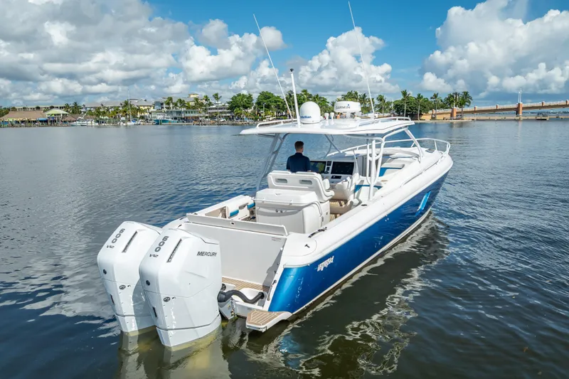 Slide: The Image of 2018 Intrepid 407 boat with dual Mercury engines on calm water. - 2