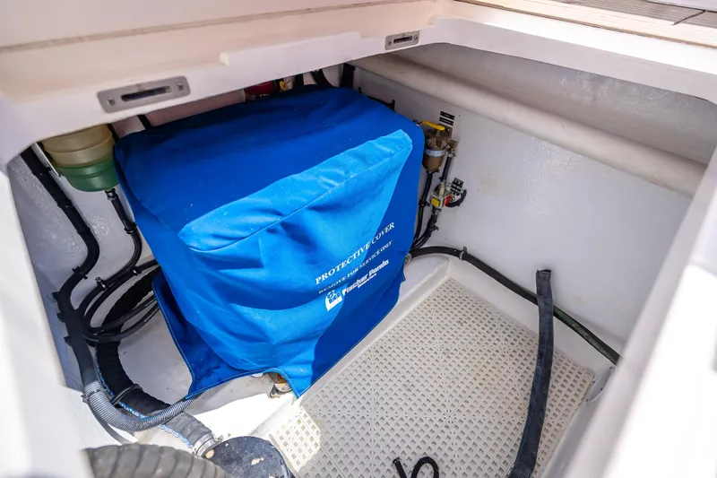Slide: The Image of Engine compartment of 2018 Intrepid 407 boat with blue protective cover. - 23