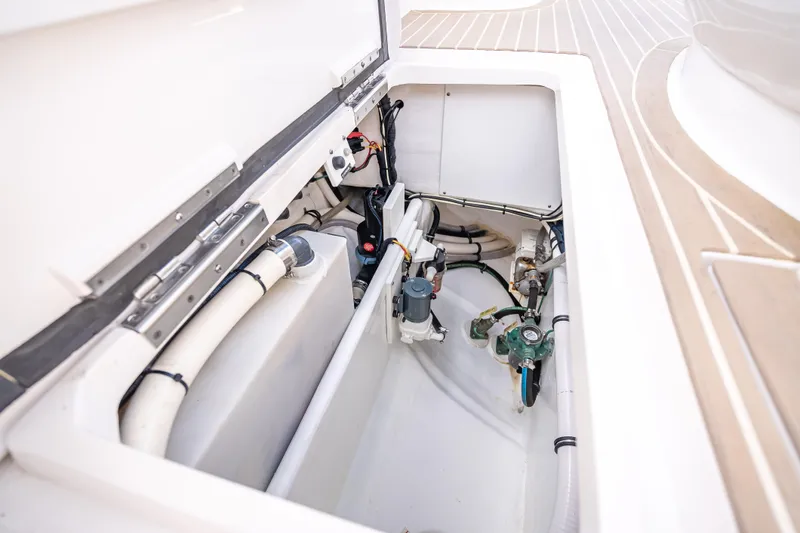 Slide: The Image of Engine compartment of a 2018 Intrepid 407 boat, showcasing mechanical components and piping. - 24