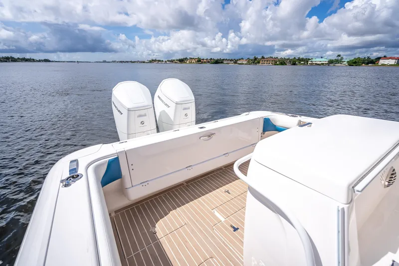 Slide: The Image of 2018 Intrepid 407 boat with dual Mercury engines on a calm lake. - 27