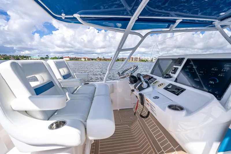 Slide: The Image of Cockpit of 2018 Intrepid 407 boat with modern controls and seating, overlooking water. - 29