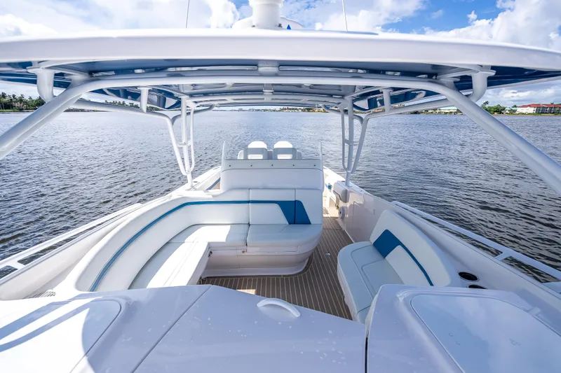 Slide: The Image of 2018 Intrepid 407 boat interior with spacious seating on a calm water backdrop. - 39