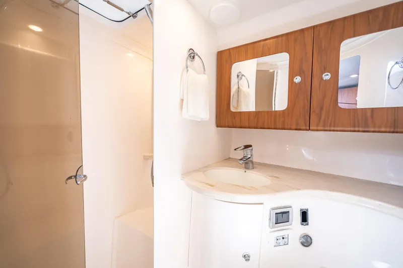 Slide: The Image of Luxurious bathroom in 2018 Intrepid 407 yacht with modern fixtures and wooden cabinetry. - 40