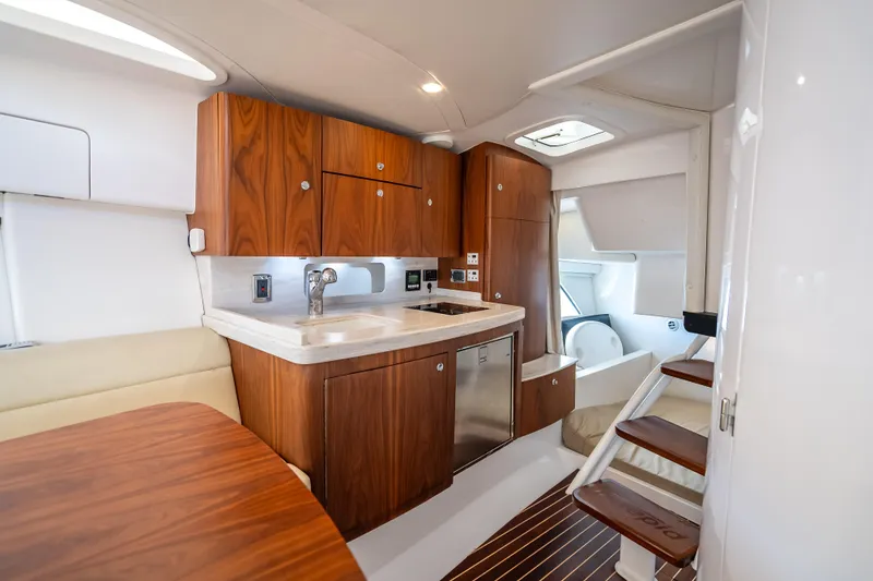 Slide: The Image of Luxurious 2018 Intrepid 407 yacht interior with modern kitchen and wooden cabinetry. - 46