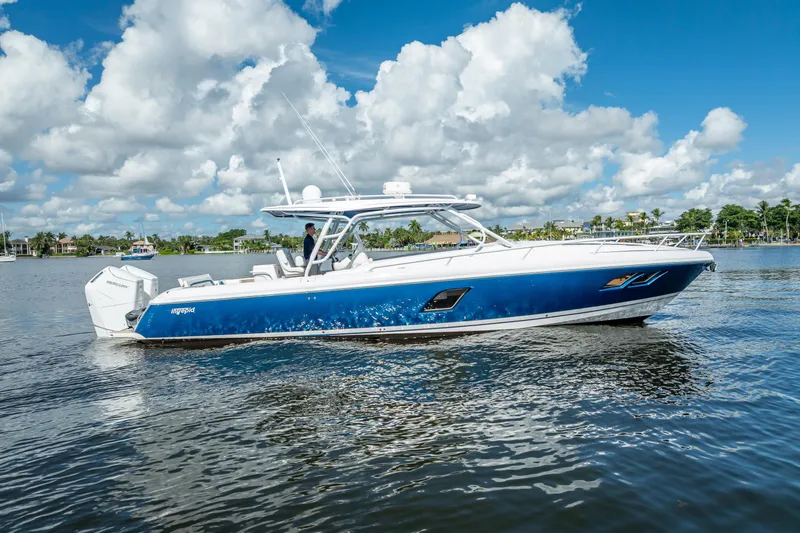 Slide: The Image of 2018 Intrepid 407 boat on calm water under a blue sky with clouds. - 6