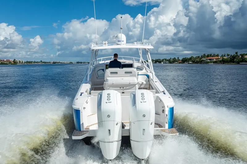 Slide: The Image of 2018 Intrepid 407 boat cruising on water with powerful engines, under a partly cloudy sky. - 7