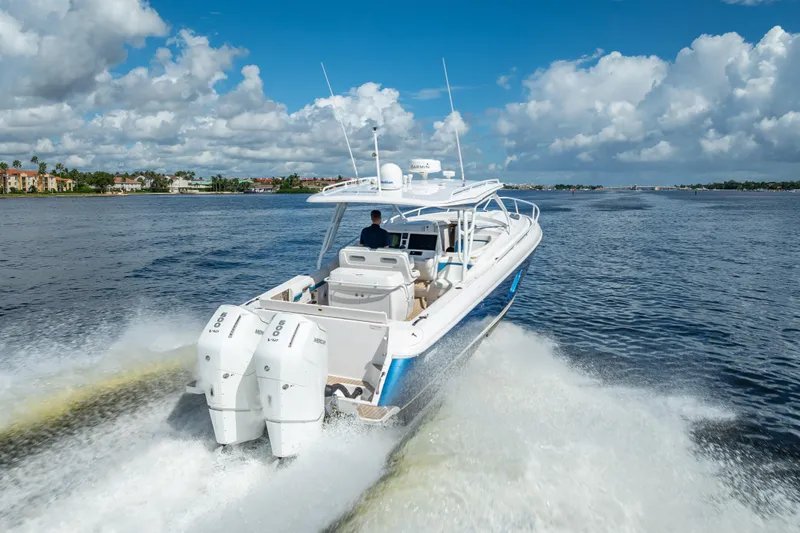 Slide: The Image of 2018 Intrepid 407 boat cruising on open water under a blue sky. - 8