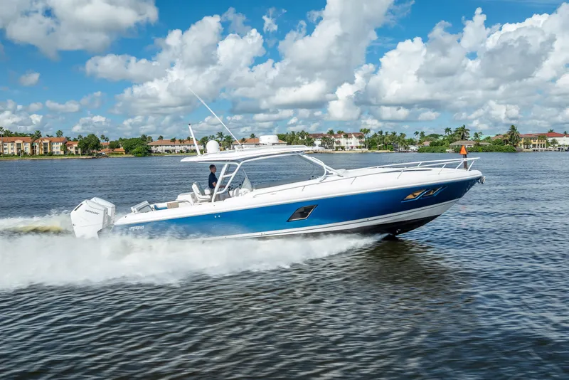 Slide: The Image of 2018 Intrepid 407 boat cruising on a sunny day, blue water and sky backdrop. - 9