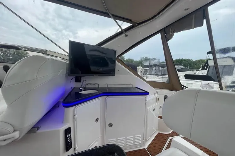 Slide: The Image of Interior of 2003 Regal Commodore 3560 IB yacht with TV and seating area. - 11