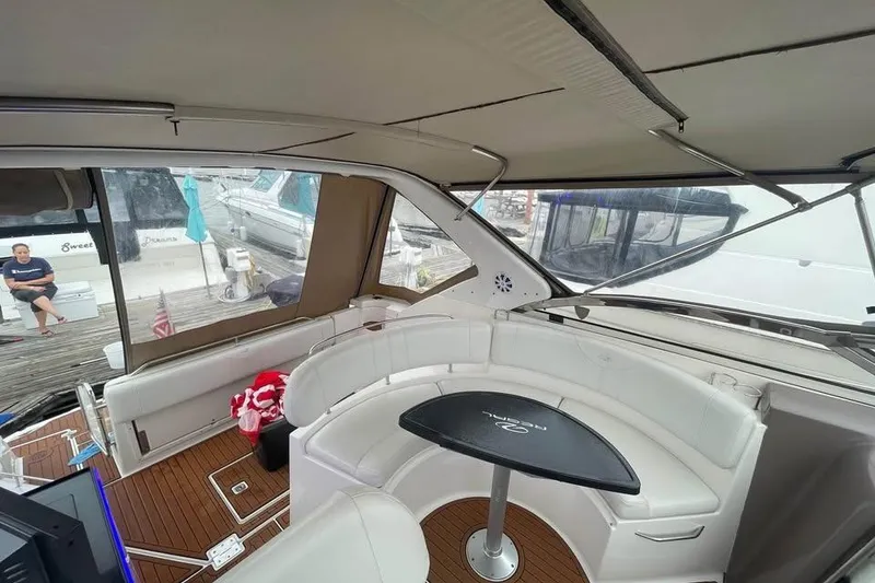 Slide: The Image of Interior of 2003 Regal Commodore 3560 IB yacht with white seating and table. - 5