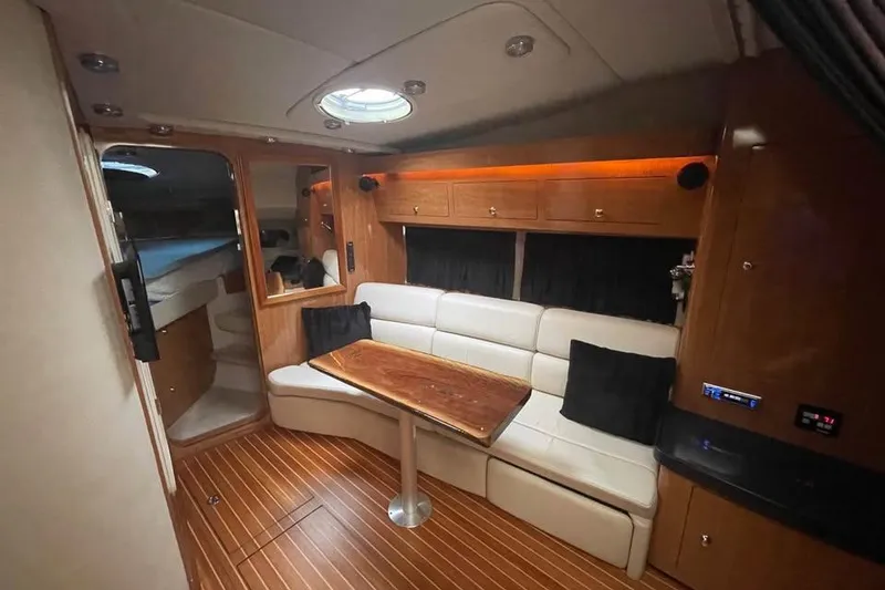 Slide: The Image of Interior of 2003 Regal Commodore 3560 IB yacht with wood flooring and cozy seating area. - 6