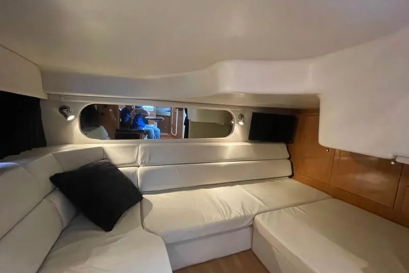 Slide: The Image of Interior of 2003 Regal Commodore 3560 IB yacht with white seating and wood accents. - 7