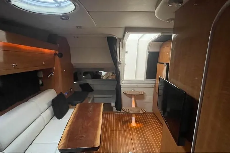 Slide: The Image of Interior of 2003 Regal Commodore 3560 IB yacht with wood accents and modern furnishings. - 8