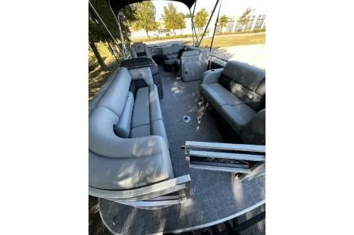 Slide: The Image of 2026 Sun Tracker SportFish 22 DLX pontoon boat with spacious seating and modern design. - 4