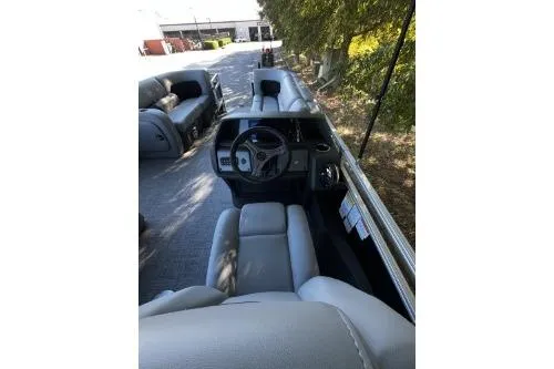 Slide: The Image of 2026 Sun Tracker SportFish 22 DLX boat interior with steering console and seating. - 5