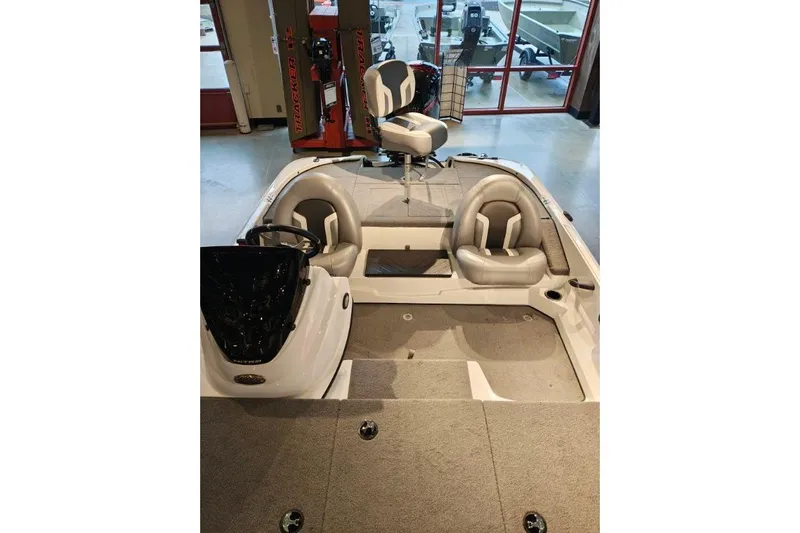 Slide: The Image of 2026 Nitro Z17 boat interior with seating and steering console in showroom. - 4
