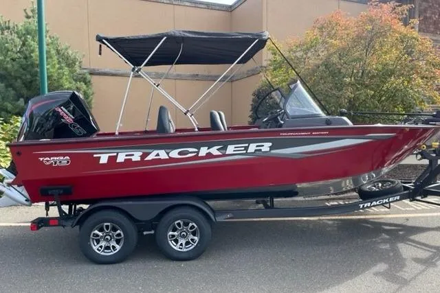 The Image of 2026 Tracker Targa V-19 Combo boat with canopy on trailer, parked outdoors. - 0