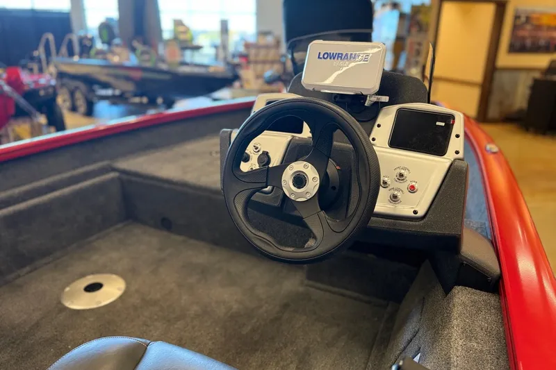 Slide: The Image of 2026 Tracker Pro Team 175 Crappie Edition boat interior with steering wheel and Lowrance display. - 11